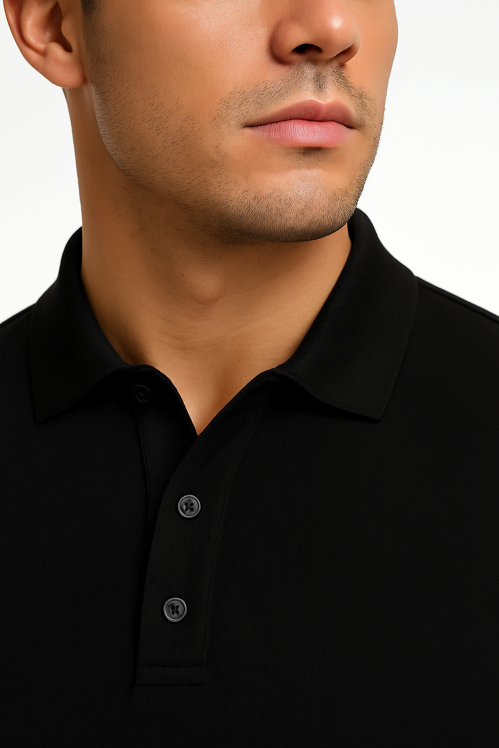 Close-up of a person wearing a black polo shirt with a plain background