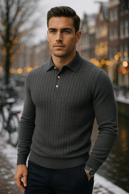Man wearing a gray sweater standing in an urban setting with blurred lights in the background