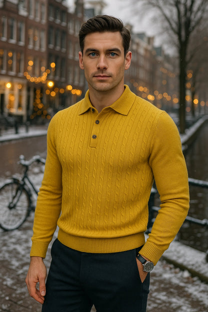 Man wearing a yellow sweater standing in an urban setting with blurred lights in the background