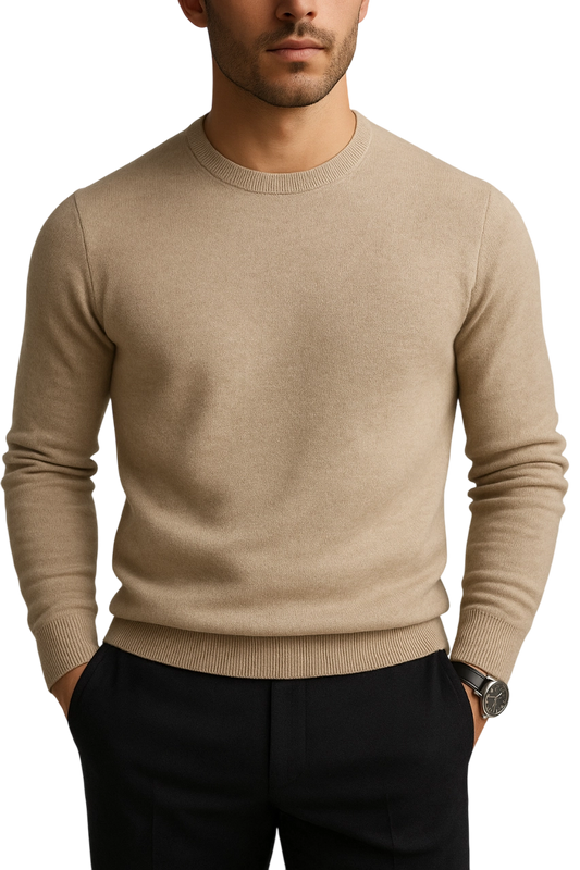 Man wearing a beige sweater and black pants on a white background