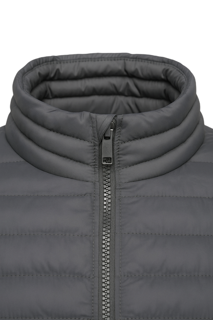 Close-up of a gray puffer jacket with a zipper on a white background
