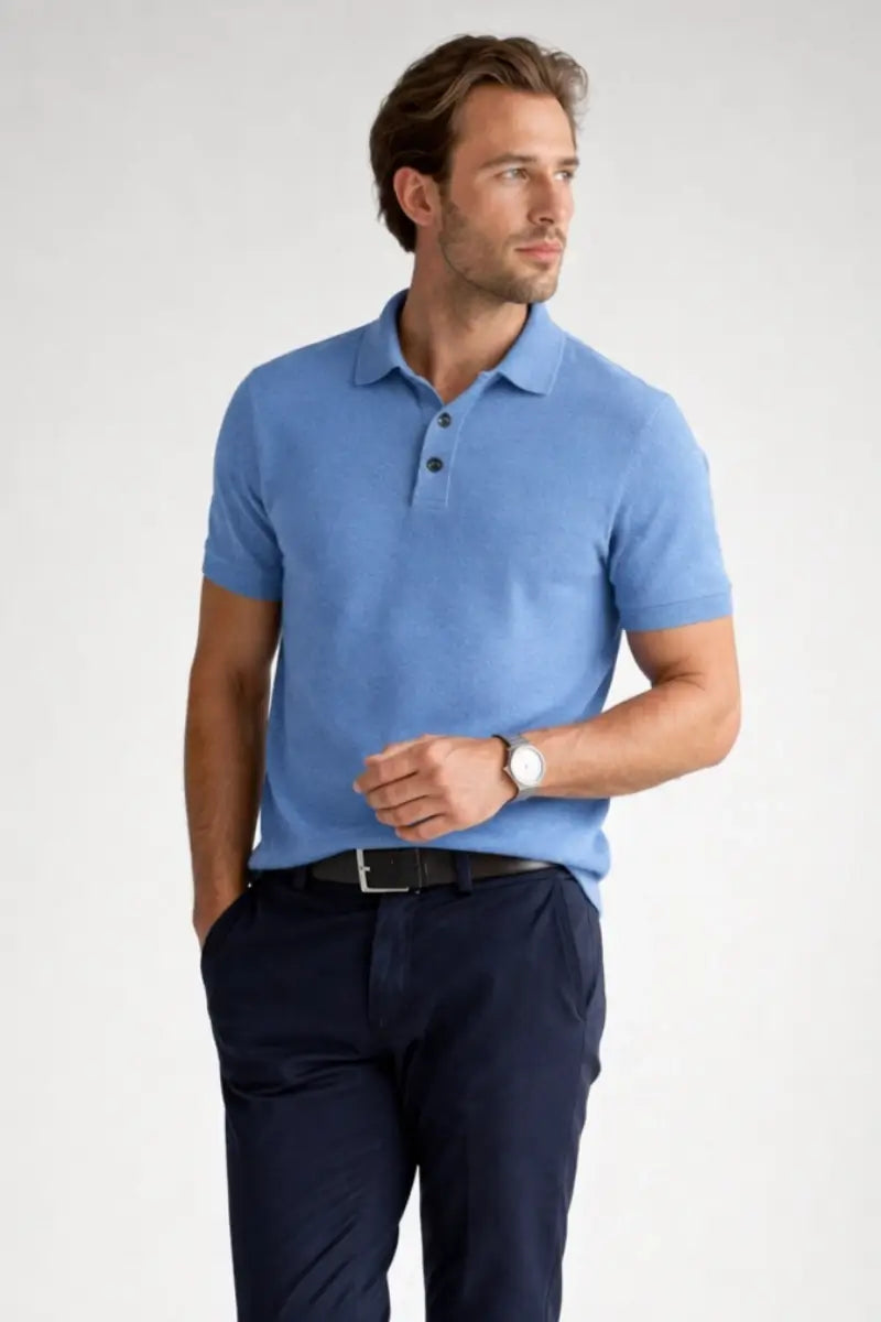Man wearing a blue polo shirt and navy pants on a white background